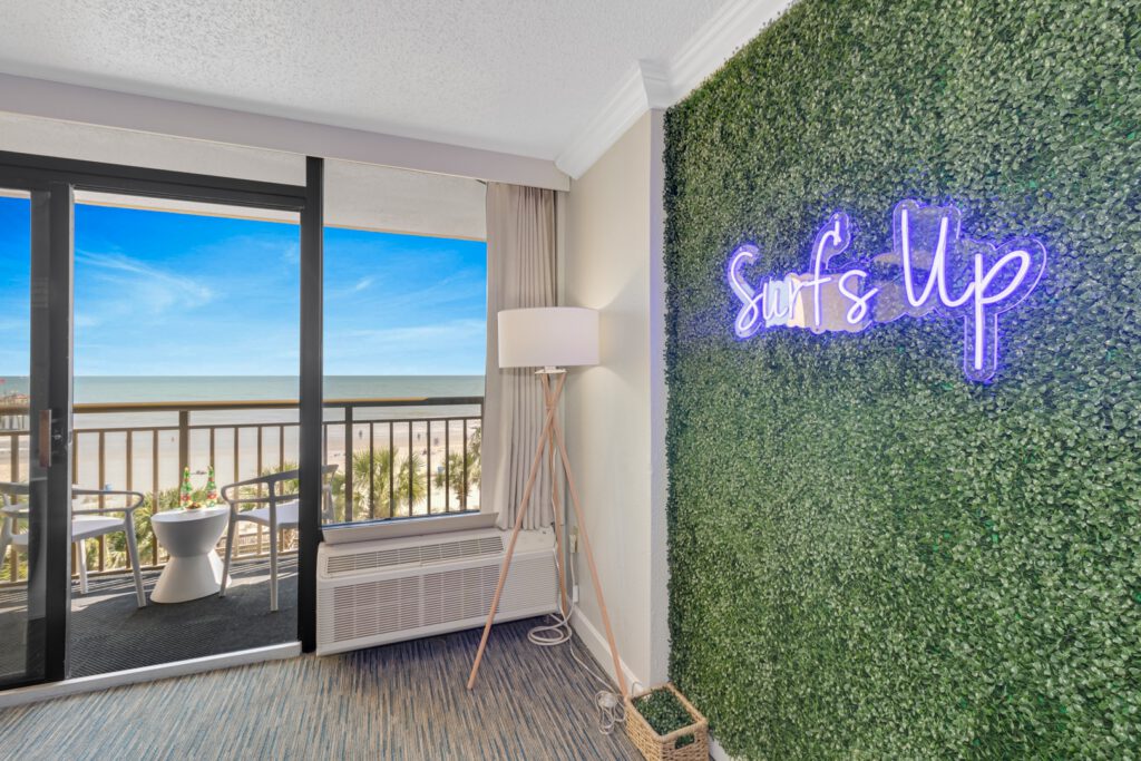 Surf Pavilion vacation rental suite living area with neon accent wall at StayMareni